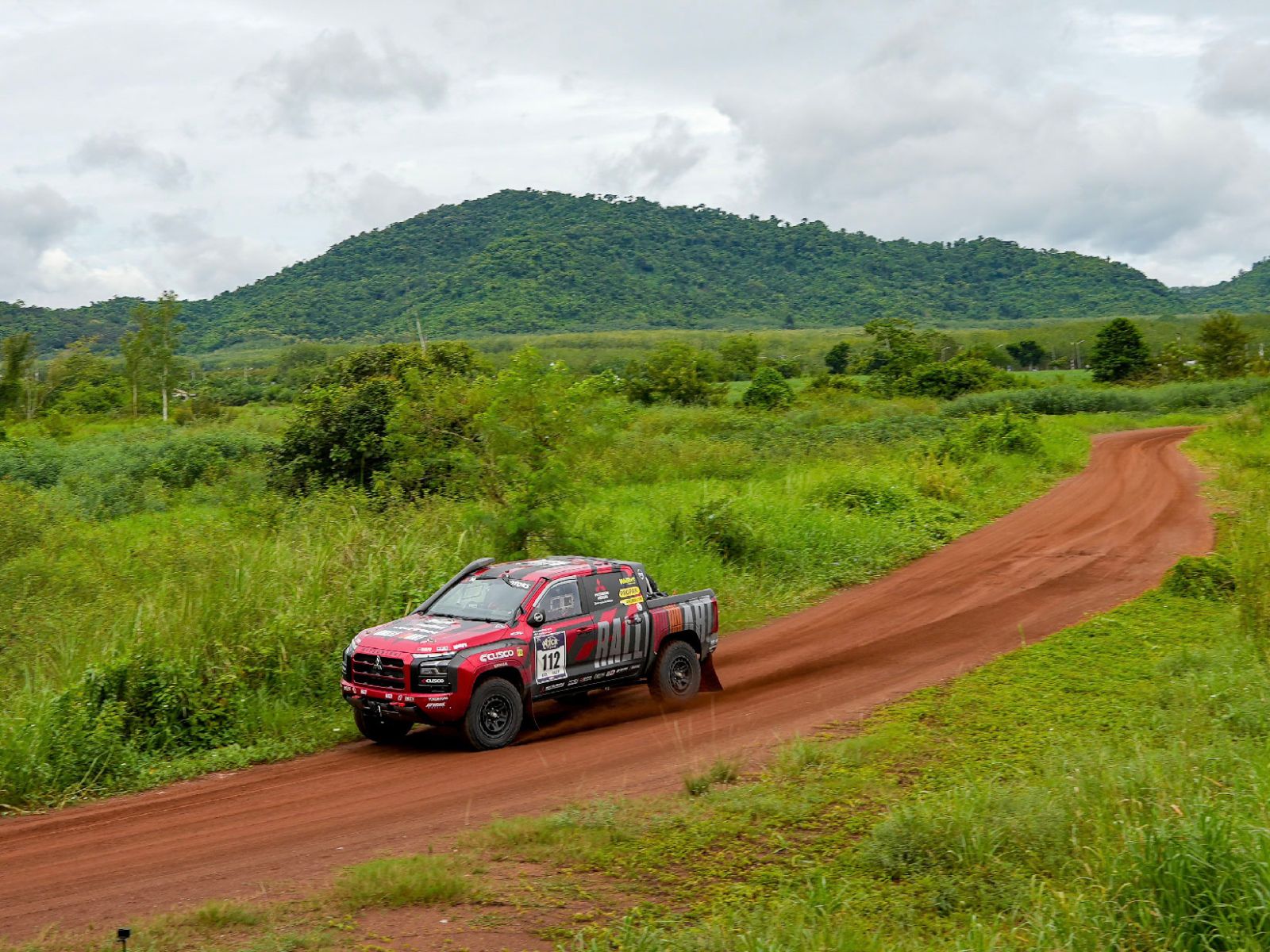 Mitsubishi Ralliart Triton AXCR in dirt, overlooking ascenic moubtain