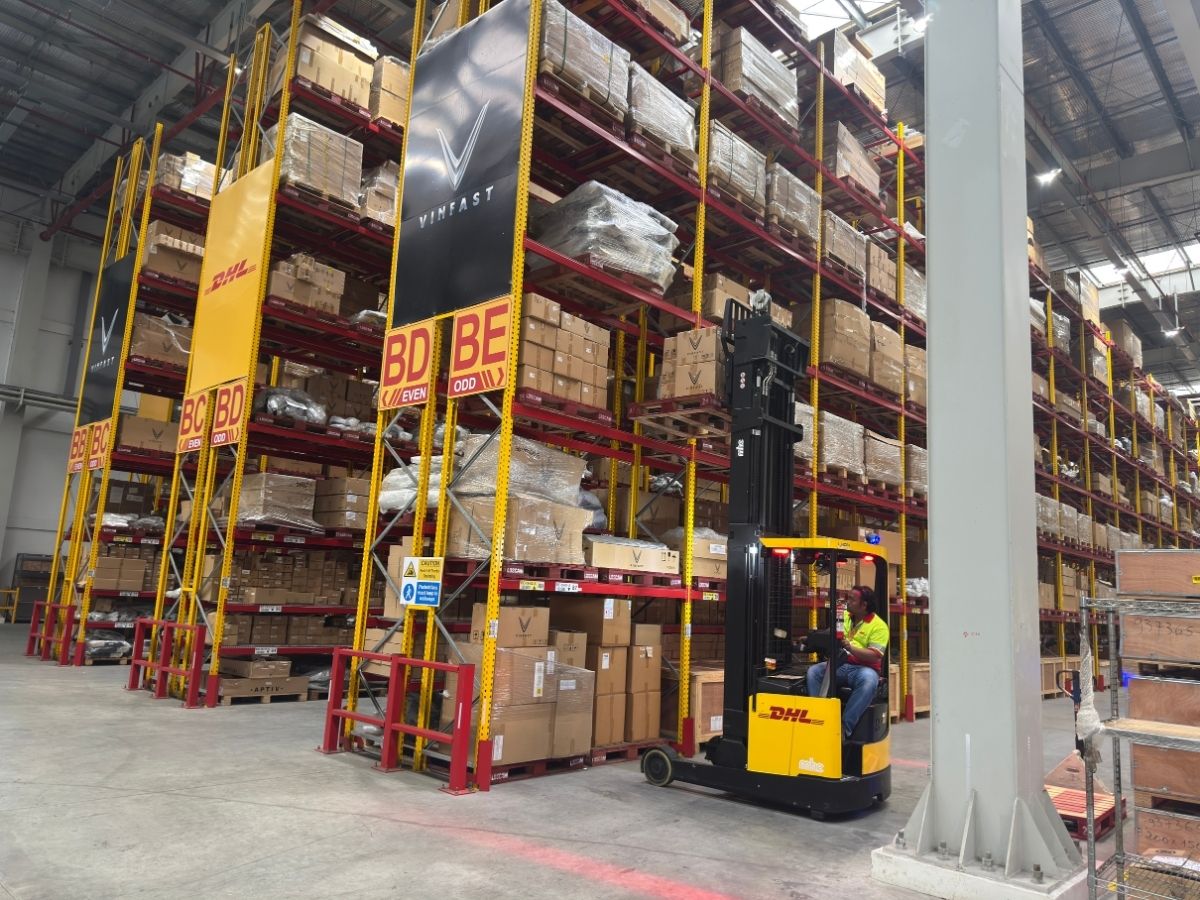 VinFast PH x DHL Philippines partnership warehouse facility. DHL Forklift retrieves component box from high up in the shelf