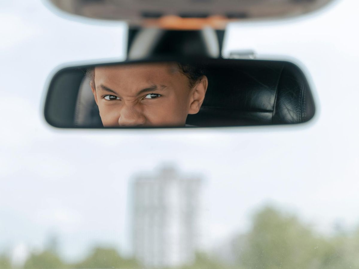 Angry man reflected in rear view mirror